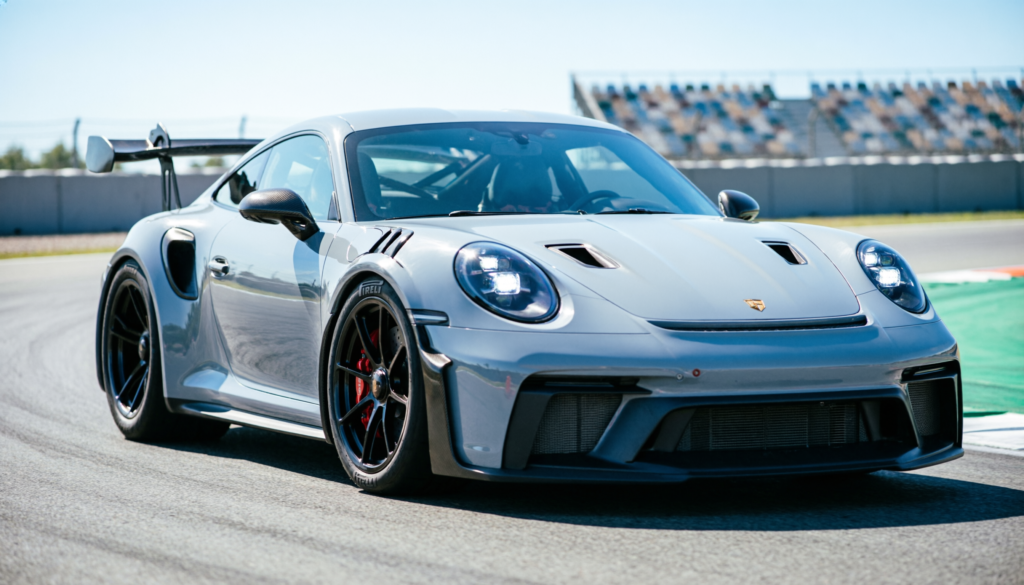 2026 Porsche 911 GT3 RS Weissach Package in Ice Grey Metallic attacking a racetrack turn